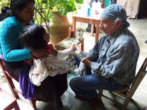 Don Sergio attending young Maya girl